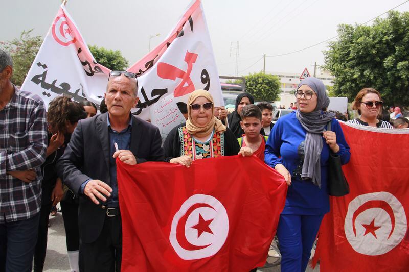 Tunisians take part in a protest against the presence of sub-Saharan migrants who have found themselves stranded as the country ramps up its border patrol efforts, in Jebeniana, Tunisia, Saturday, May 18, 2024. Anti-migrant anger is mounting in olive-growing towns along the Tunisian coastline that have emerged as a launchpad for thousands of people hoping to reach Europe by boat. (AP Photo/Houssem Zouari)