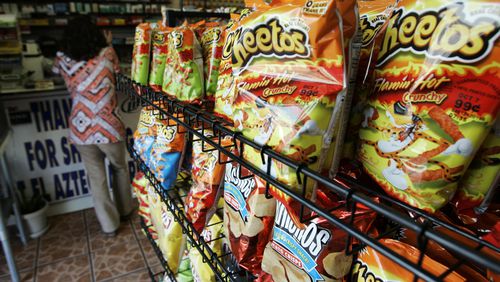FILE - Flamin' Hot Cheetos are pictured near the front door of La Azteca Market in South Los Angeles, Aug. 22, 2008. The man who says he invented Flamin' Hot Cheetos filed a lawsuit against his former employers Thursday, July 18, 2024, for fraud, defamation and other violations, saying he was harmed when Frito-Lay and PepsiCo denied his role in creating the popular hot snack. (AP Photo/Reed Saxon)