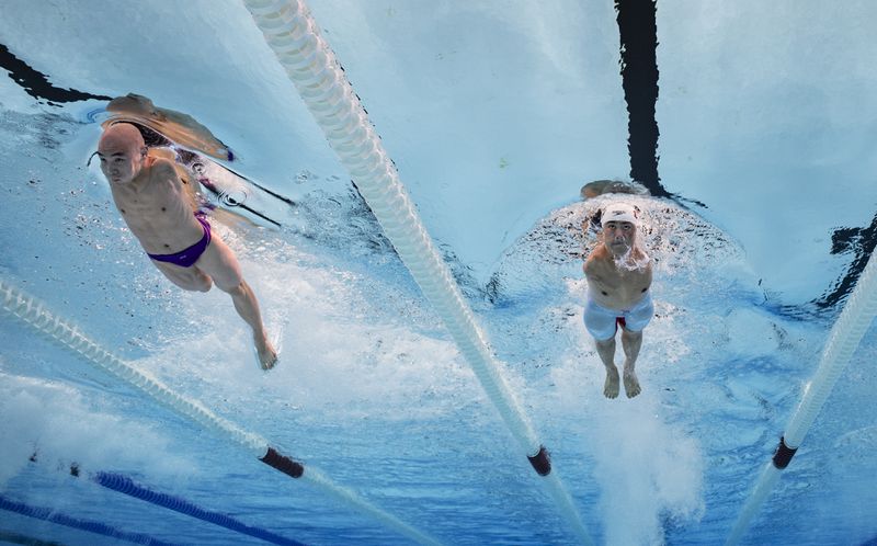 China's Weiyi Yuan, right, and China's Jincheng Guo compete in the Para Swimming Men's 50m Freestyle - S5 Final at the Paris La Defense Arena at the Paris 2024 Paralympic Games, Paris, France, Thursday Sept. 5, 2024. (Joel Marklund/OIS/IOC via AP)