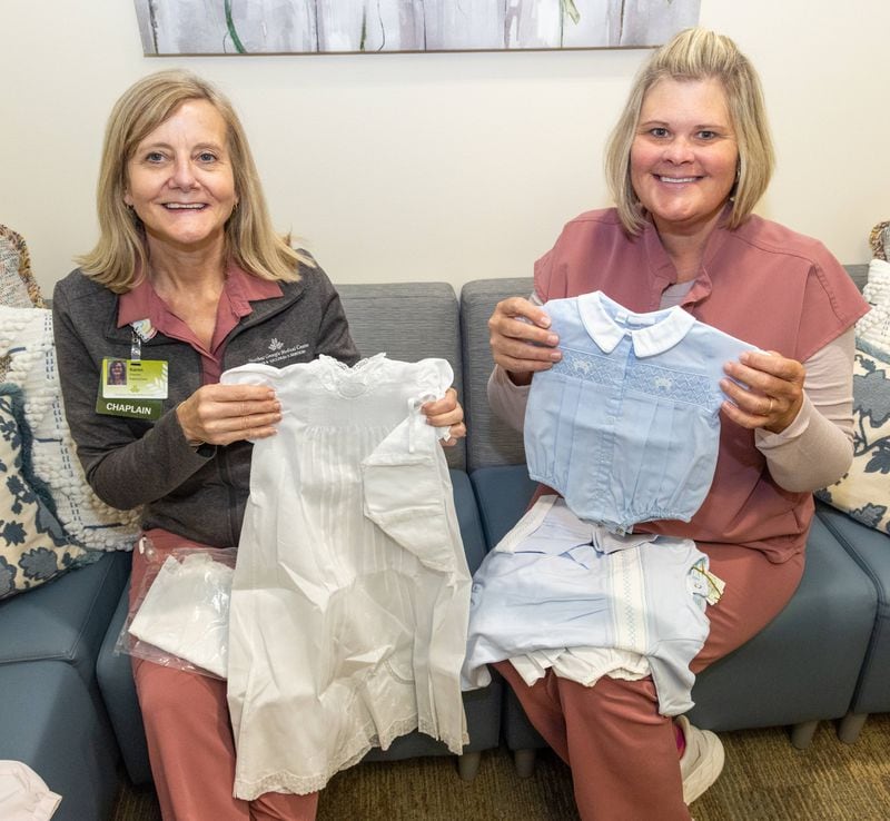  Northeast Georgia Medical Center Bereavement team members Chaplain Reverend Karen Hoyt M.Div, BCC (left) and Mandy Reichert, PhD, RN, PT-CSP hold up some of their assortment of baby clothes that they can offer for burials. A nurse who has the sad duty of dressing for burial babies that don't make it contacted a manufacturer of really smart children's clothes. He has given them some and they are needed because some parents don't have or can't afford a proper burial outfit for their babies. PHIL SKINNER FOR THE ATLANTA JOURNAL-CONSTITUTION