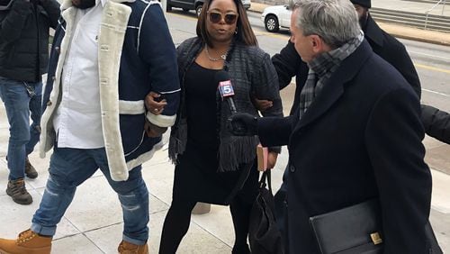 A former top aide to former Mayor Kasim Reed, Katrina Taylor-Parks (center), enters federal court in Atlanta Jan. 14. She pleaded guilty last year, admitting to taking bribes from a city vendor.
