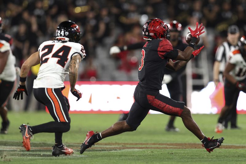 San Diego State wide receiver Ja'Shaun Poke, right, catches the ball chased by Oregon State defensive back Jack Kane (24) during the second half of an NCAA college football game Saturday, Sept. 7, 2024, in San Diego. (AP Photo/Raul Romero Jr.)