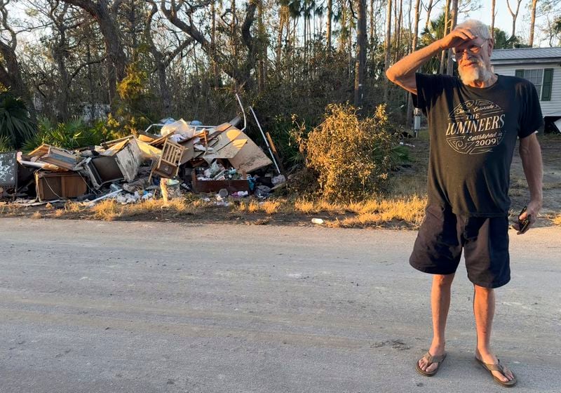 Dave Beamer surveys debris left behind by Hurricane Helene along his street in Steinhatchee, Fla., Sunday. Sept. 29, 2024. Beamer had just rebuilt his home in the wake of Hurricane Idalia in August 2023, before Helene washed it into a marsh. (AP Photo/Kate Payne)