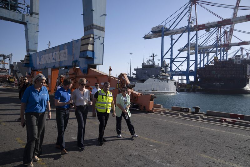 U.S. Agency for International Development Administrator Samantha Power, center, talks with Antoine Renard, World Food Program (WFP) country director, center left, as they visit the port where cargo ships arrive, carrying humanitarian aid for Gaza Strip, in Ashdod, Israel, Thursday, July 11, 2024. (AP Photo/Leo Correa)