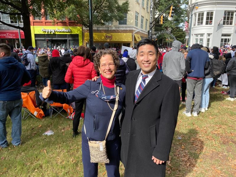 State Reps. Becky Evans and Sam Park walked down from the Gold Dome on Friday, Nov. 5, 2021, to soak in the Braves World Series parade. (Ben Brasch / Ben.Brasch@ajc.com)