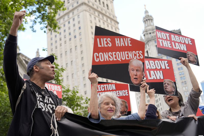 People react to the guilty verdict announced against former President Donald Trump outside Manhattan Criminal Court last month. A jury found him guilty of 34 felony counts of falsifying business records.