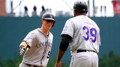 DJ LeMahieu of the Colorado Rockies celebrates a solo home run with third base coach Stu Cole during the third inning against the Atlanta Braves at SunTrust Park on August 19, 2018 in Atlanta, Georgia. (Photo by Daniel Shirey/Getty Images)