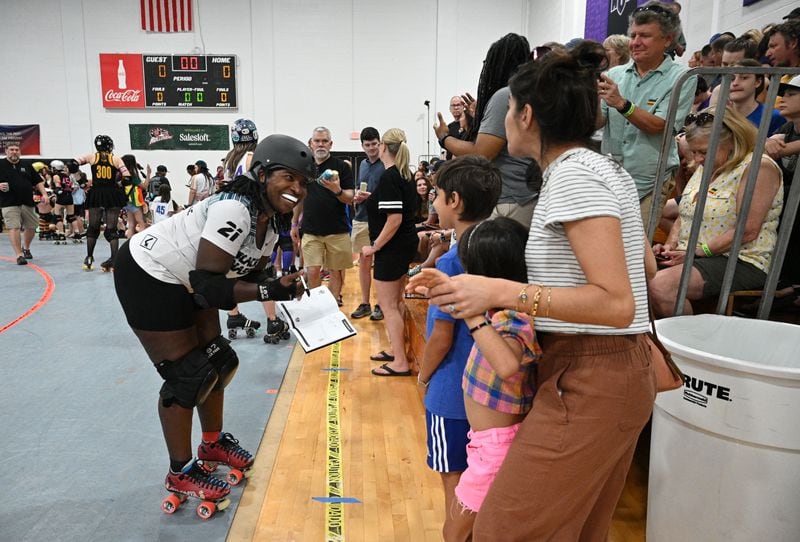 Jacqueline Thermitus (#21), reacts as she signs autographs for fans during Atlanta Roller Derby game at Agnes Scott College’s Woodruff Athletic Complex, Saturday, June 8, 2024, in Decatur. (Hyosub Shin / AJC)