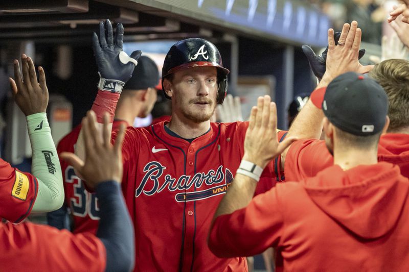 Atlanta Braves' Sean Murphy, center, celebrates in the dugout after hitting a two-run home run in the fourth inning of a baseball game against the Kansas City Royals, Friday, Sept. 27, 2024, in Atlanta. (AP Photo/Jason Allen)