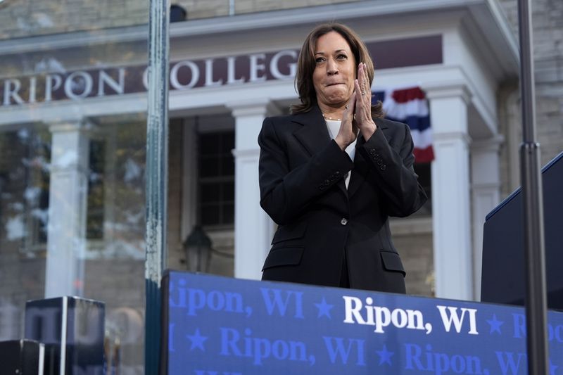 Democratic presidential nominee Vice President Kamala Harris applauds at a campaign event with former Congresswoman Liz Cheney, R-Wyo., at Ripon College in Ripon, Wis., Thursday, Oct. 3, 2024. (AP Photo/Mark Schiefelbein)