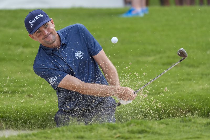 Keegan Bradley hits out of a bunker on the 17th hole during the second round of the Charles Schwab Challenge golf tournament at Colonial Country Club, Friday, May 24, 2024, in Fort Worth, Texas. (AP Photo/LM Otero)