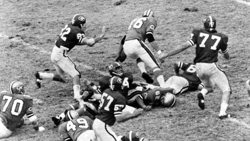 Bill Stanfill (77) was an All-American defensive tackle at UGA, and later became an All-Pro with the NFL’s Miami Dolphins. Here he causes chaos against Georgia Tech during a Bulldogs’ victory in 1960s.