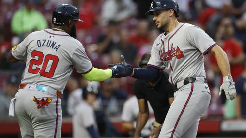 Atlanta Braves' Matt Olson, right, celebrates his home run against the Cincinnati Reds with teammate Marcell Ozuna during the first inning of a baseball game, Tuesday, Sept. 17, 2024, in Cincinnati. (AP Photo/Jay LaPrete)