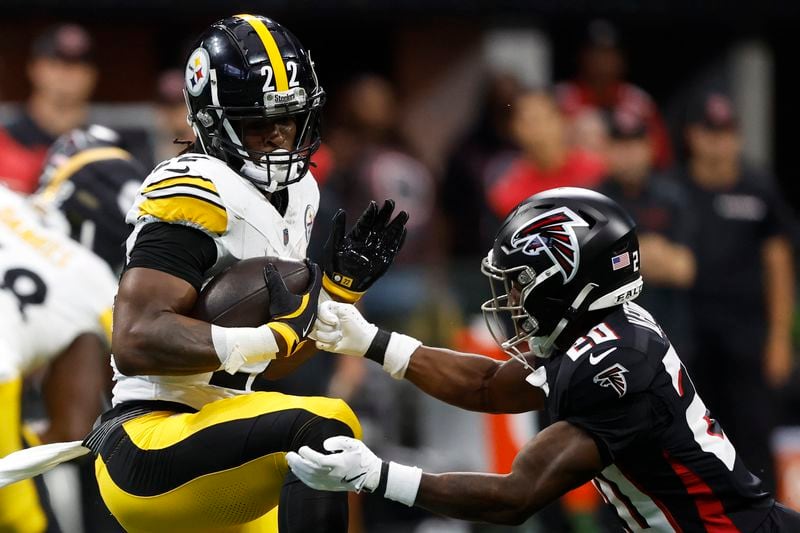 Pittsburgh Steelers running back Najee Harris, left, breaks a tackle as Atlanta Falcons cornerback Dee Alford (20) closes in during the first half of an NFL football game Sunday, Sept. 8, 2024, in Atlanta. (AP Photo/Butch Dill)