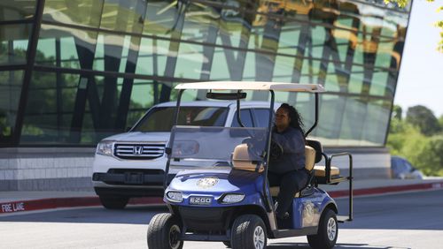 Campus Security Officer Nanyamka Jones drives a golf carts to patrol the exterior of Jonesboro High School, Wednesday, May 3, 2023, in Jonesboro, Ga. Clayton County Public School purchased golf carts to patrol and secure the exterior of each campuses. (Jason Getz / Jason.Getz@ajc.com)