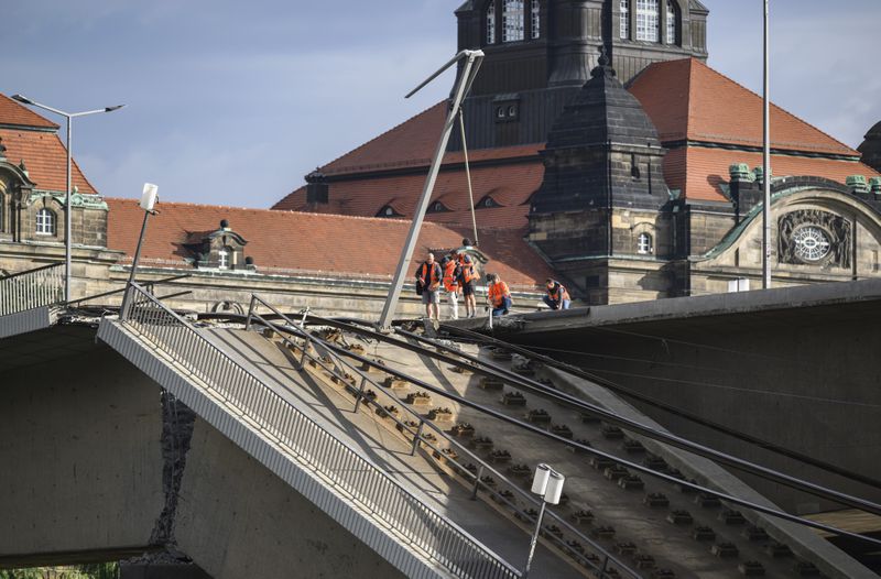 Parts of the Carola Bridge over the Elbe have collapsed in Dresden, Germany, Wednesday, Sept. 11, 2024. The State Chancellery can be seen behind it. (Robert Michael/dpa via AP)