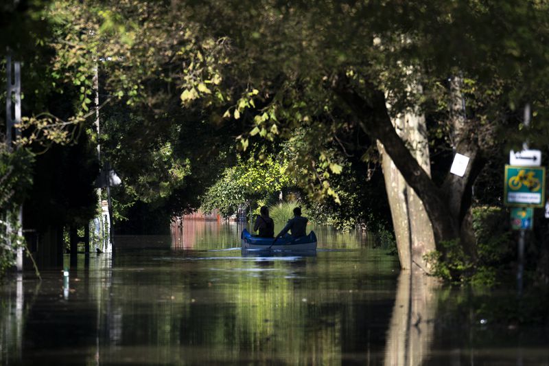 People use a canoe on the outskirts of Szentendre, near Budapest, Hungary, as the Danube river floods its banks on Thursday, Sept. 19, 2024. (AP Photo/Denes Erdos)