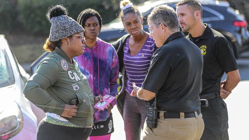 Deonna Bray (left) speaks with Clarkston police Chief Christine Hudson (second from right) during the search for Bray's missing 1-year old, Blaise Barnett. It's been one week since the mother and child were reunited, and Clarkston police said they have not identified any suspects.