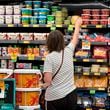 FILE - A customer looks at refrigerated items at a Grocery Outlet store in Pleasanton, Calif., Thursday, Sept. 15, 2022. (AP Photo/Terry Chea, File)