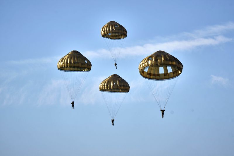 Parachutists jump over Ginkel Heath Netherlands, Saturday, Sept. 21, 2024, to mark the 80th anniversary of an audacious by unsuccessful World War II mission codenamed Market Garden to take key bridges in the Netherlands. (AP Photo/Phil Nijhuis)