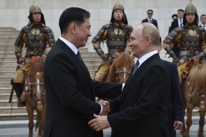 Russian President Vladimir Putin, right, and Mongolian President Ukhnaagiin Khurelsukh attend a welcome ceremony in Sukhbaatar Square in Ulaanbaatar, Mongolia, Tuesday, Sept. 3, 2024. (Vyacheslav Prokofyev, Sputnik, Kremlin Pool Photo via AP)