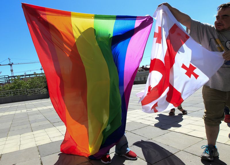 FILE - Georgian LGBTQ+ activists attend a rally against homophobia to mark the international day against homophobia, in downtown Tbilisi, Georgia, on May 17, 2017. (AP Photo/Shakh Aivazov, File)