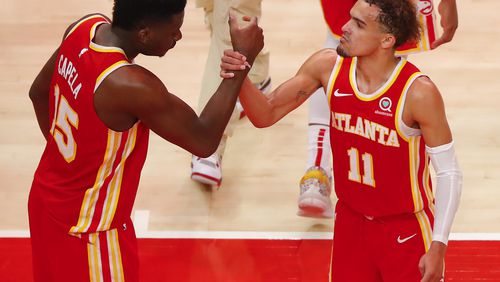 Trae Young (11) reacts with Clint Capela (15) of the Atlanta Hawks at the conclusion of the game against the New York Knicks in game three of the Eastern Conference Quarterfinals at State Farm Arena on May 28, 2021 in Atlanta, Georgia. (Todd Kirkland/Getty Images/TNS)