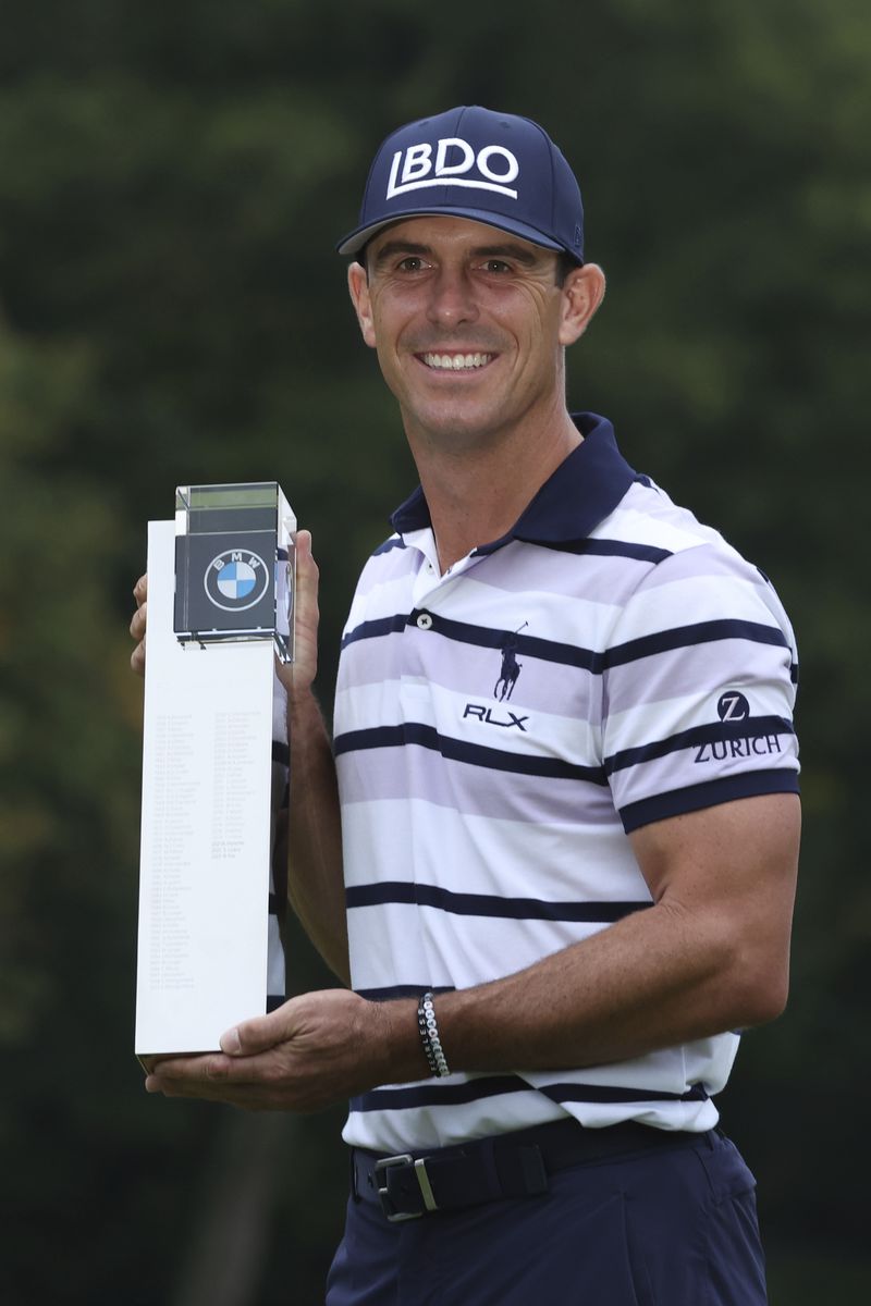 Billy Horschel of the United States poses for the media holding up the winners trophy for the British PGA golf Championship, following his playoff victory, at Wentworth golf club in Wentworth, England, Sunday, Sept. 22, 2024. (AP Photo/Ian Walton)