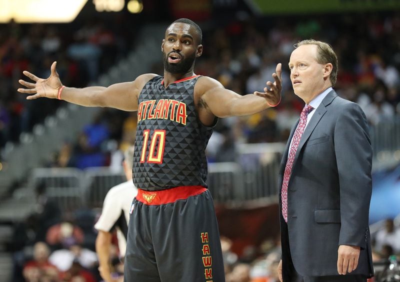 The Hawks' Tim Hardaway Jr. confers with head coach Mike Budenholzer during a 2016 game. Curtis Compton /ccompton@ajc.com