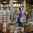 FILE - Workers carry boxes at a Strategic National Stockpile warehouse in Oklahoma City, Okla., April 7, 2020. (AP Photo/Sue Ogrocki, File)