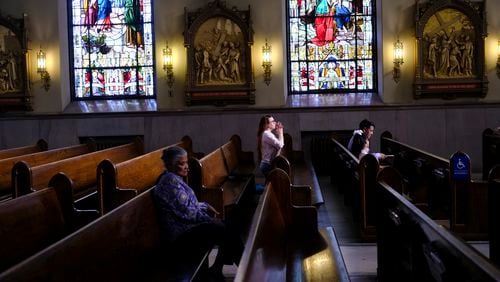 A parishioner prays at St. Peter the Apostle Catholic Church in Reading, Pa., on Sunday, June 16, 2024. Reading is 67% Latino, according to U.S. Census figures, and home to high concentrations of people of Dominican and Puerto Rican heritage — as well as Colombians and Mexicans, who own restaurants and other businesses around town. (AP Photo/Luis Andres Henao)