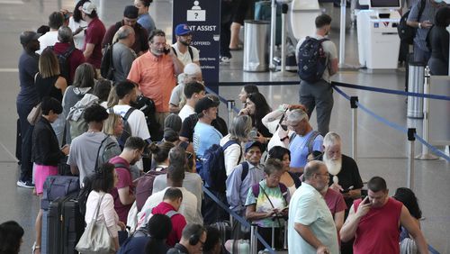 FILE - Passengers wait in line for assistance at the Delta Terminal, July 19, 2024, at Logan International Airport in Boston. Delta CEO Ed Bastian says the airline is facing $500 million in costs for the global technology breakdown that happened earlier this month. (AP Photo/Michael Dwyer, File)