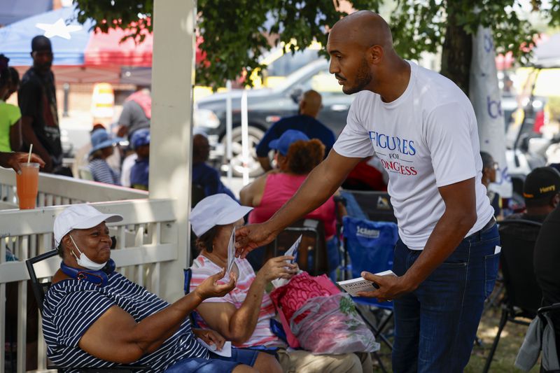 Alabama's new 2nd Congressional District Democratic candidate Shomari Figures greets voters during the Macon County Day Festival in Tuskegee, Ala., on Saturday, Aug 31, 2024. (AP Photo/ Butch Dill)