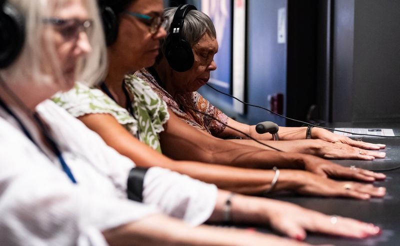 Rev. Dr. Cynthia Roddey, (far right), participates in an exhibit simulating a civil rights era lunch counter sit-in with her daughter-in-law Lorie Blount, center, and Blount’s mother Robbie Luck at the National Center for Civil and Human Rights in Atlanta on Thursday, July 11, 2024. Roddey was the first African-American graduate student to enroll at Winthrop University. (Seeger Gray / AJC) 