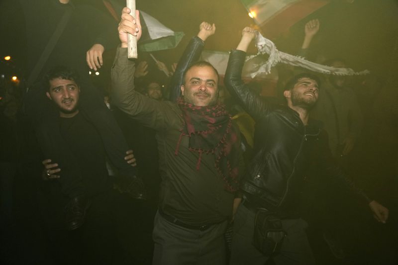 Demonstrators celebrate Iran's missile strike against Israel during a gathering in front of the British Embassy in Tehran, Iran, Tuesday, Oct. 1, 2024. (AP Photo/Vahid Salemi)