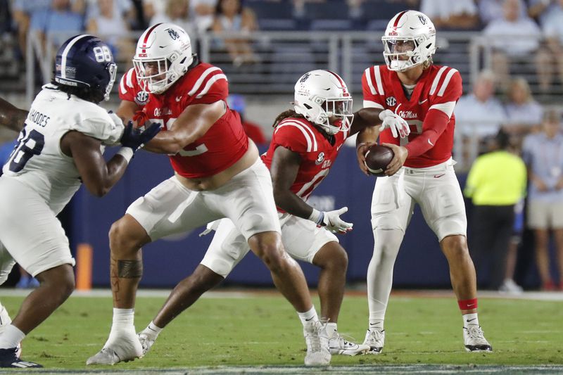 Mississippi quarterback Jaxson Dart, right, hands the ball to running back Matt Jones (0) during the first half of an NCAA college football game against Georgia Southern, Saturday, Sept. 21, 2024, in Oxford, Miss. (AP Photo/Sarah Warnock)