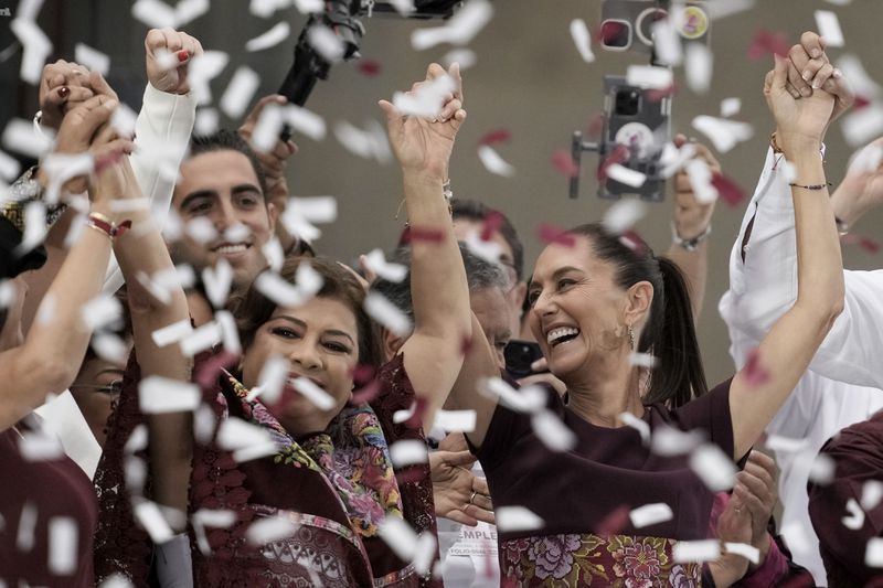 FILE - Confetti showers presidential candidate Claudia Sheinbaum, right, during her closing campaign rally at the Zocalo in Mexico City, May 29, 2024. Sheinbaum, a climate scientist and former Mexico City mayor, will be sworn in as Mexico’s first woman president on Oct. 1. (AP Photo/Eduardo Verdugo, File)