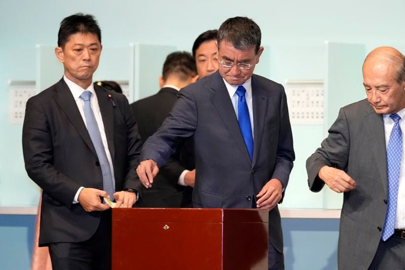 One of candidates Taro Kono, center, casts his ballot at the ruling Liberal Democratic Party's (LDP) leadership election Friday, Sept. 27, 2024, in Tokyo. (AP Photo/Hiro Komae, Pool)