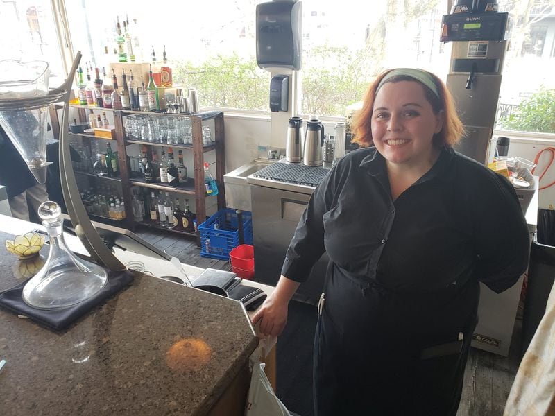 Amanda Gabrell works as a server at the Epicurean Cafe in Duluth. The part-time work helps supplement what she makes at her full-time job in billing. With restaurant goers scaling back during the coronavirus outbreak, Gabrell has contemplated how to navigate the potential financial setback. MATT KEMPNER / AJC