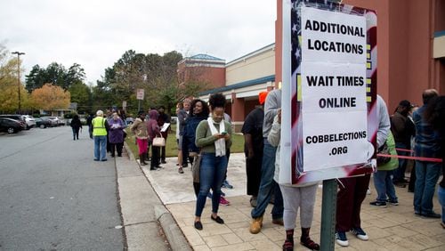 People wait in a long line to vote Saturday at the Cobb County Board of Elections and Registration Office in Marietta. STEVE SCHAEFER / SPECIAL TO THE AJC