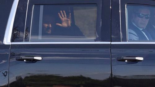 Ukrainian President Volodymyr Zelenskyy waves from the back seat of a U.S. Secret Service vehicle as his motorcade departs the Wilkes-Barre/Scranton International Airport in Pittston Township, Pa. en route to the Scranton Army Ammunition Plant in Scranton, Pa. on Sunday, Sept. 22, 2024. (Christopher Dolan/The Times-Tribune via AP)