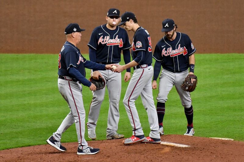 Braves starting pitcher Max Fried, center, is removed from the mound by manager Brian Snitker, left, during the sixth inning. Hyosub Shin / Hyosub.Shin@ajc.com