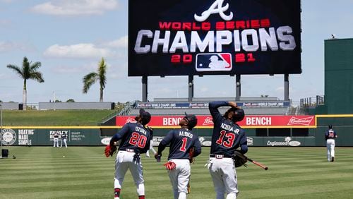 Braves outfielder Marcell Ozuna (from left), second baseman Ozzie Albies and outfielder Ronald Acuna watch out for a pop fly at CoolToday Park during a spring training workout March 14 in North Port, Fla. All three are ranked among baseball's "top 10 players right now" at their positions by MLB Network. (Curtis Compton / Curtis.Compton@ajc.com)
