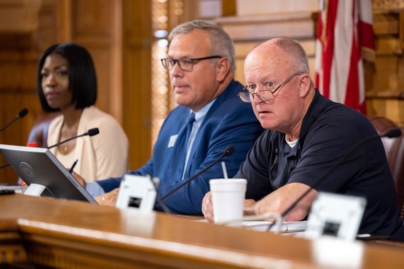 (Left to right): State Election Board member Janelle King, executive director Mike Coan and board member Rick Jeffares appear at a hastily called State Election Board meeting in Atlanta on Friday. 