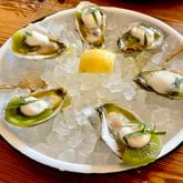 At Fishmonger, you can get oysters served with extra virgin olive oil, kiwi, tarragon and citrus foam. (Angela Hansberger for The Atlanta Journal-Constitution)