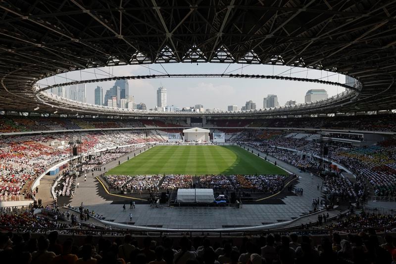 People wait for the arrival of Pope Francis before a mass at the Gelora Bung Karno Stadium in Jakarta, Thursday, Sept. 5, 2024. (Yasuyoshi Chiba/Pool Photo via AP)