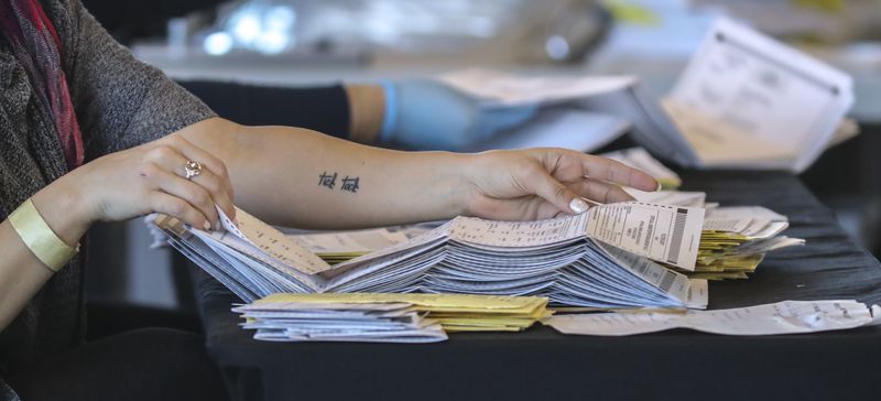 Fulton County election workers count absentee ballots at State Farm Arena on Nov. 5, 2020.