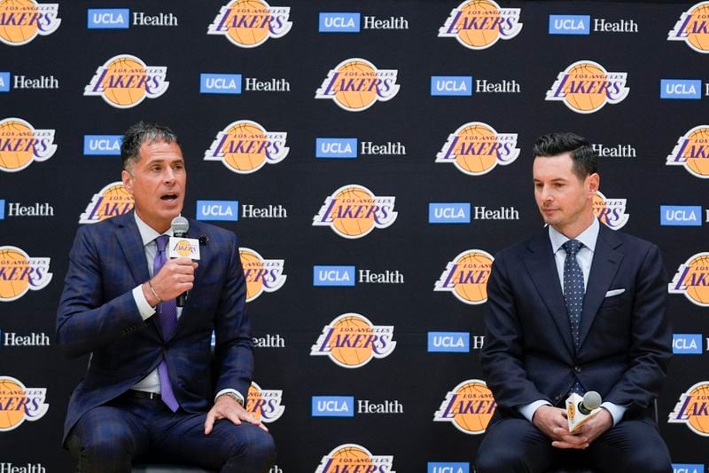 JJ Redick, right, sits on a stage with Los Angeles Lakers general manager Rob Pelinka after being introduced as the new head coach of the Lakers NBA basketball team Monday, June 24, 2024, in El Segundo, Calif. (AP Photo/Damian Dovarganes)