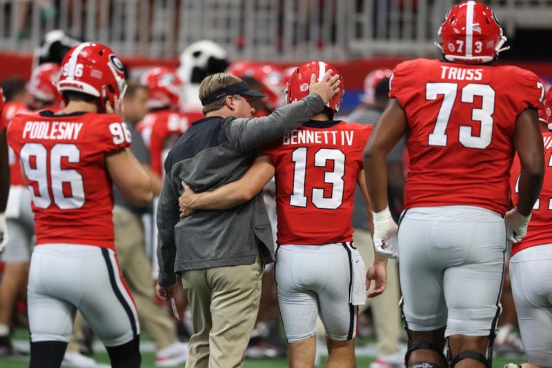 Georgia Bulldogs head coach Kirby Smart walks with quarterback Stetson Bennett (13) before their game against the Oregon Ducks at Mercedes Benz Stadium, Saturday, September 3, 2022, in Atlanta. (Jason Getz / Jason.Getz@ajc.com)