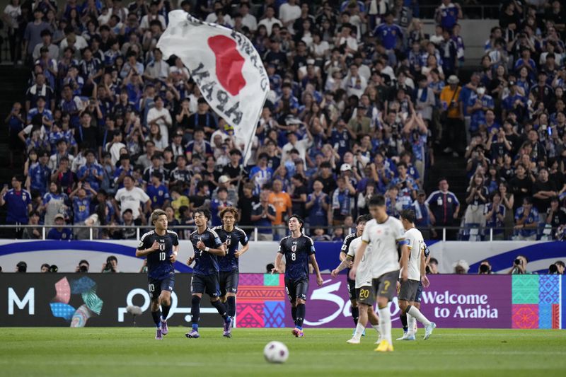 Japan's Kaoru Mitoma, left, celebrates his teams second goal during a World Cup and AFC Asian Qualifier between Japan and China at Saitama Stadium 2002 in Saitama, north of Tokyo, Thursday, Sept. 5, 2024.(AP Photo/Shuji Kajiyama)